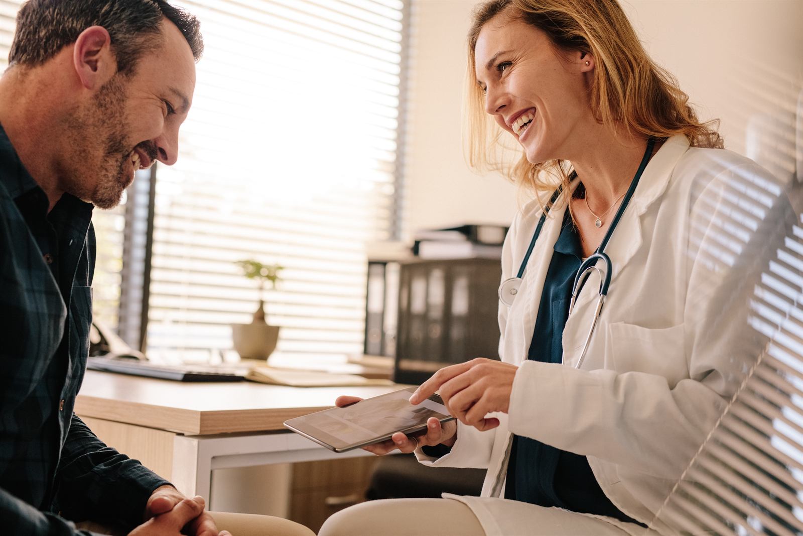 A provider reviewing test options and pricing with a patient on a tablet